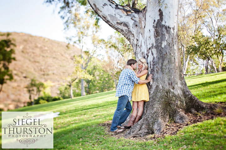 romantic engagement shoot under the trees at Poway lake in San Diego