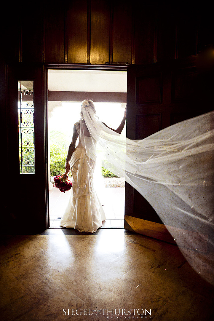 bride with her veil blowing behind her