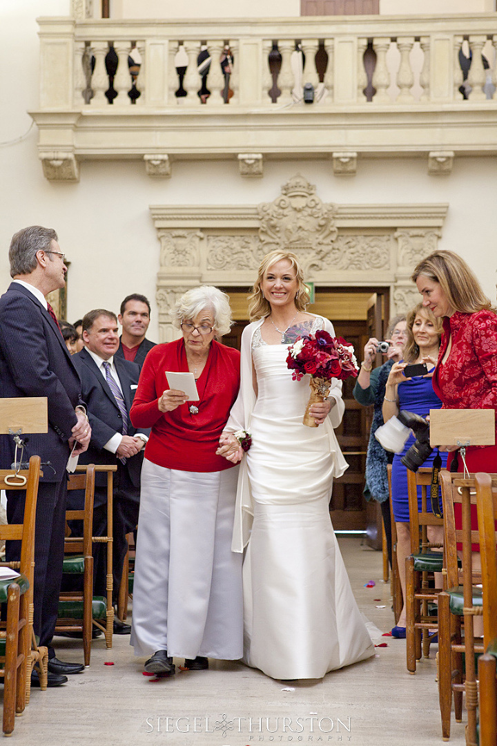 bride walking down the aisle with her mother