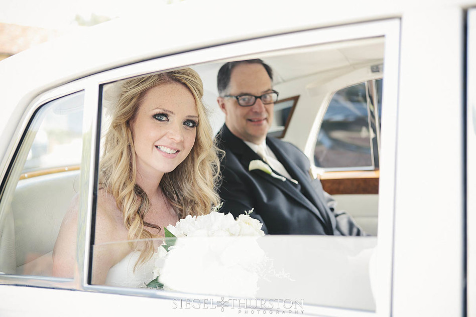 bride and her father in a vinage Bentley before the ceremony