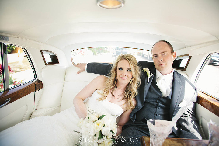 bride and groom sharing a moment in the wedding Bentley