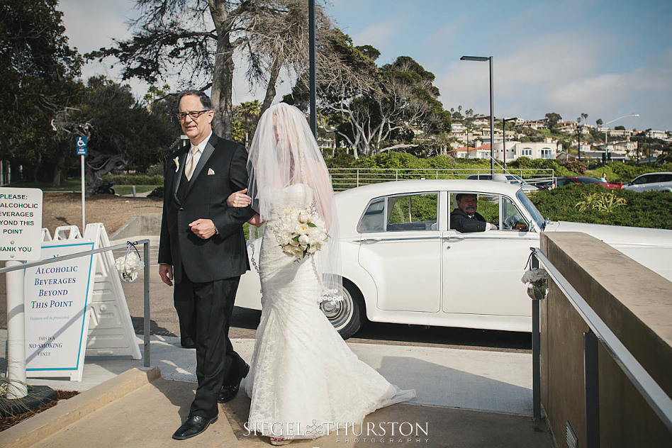 bride getting out of a vintage wedding car