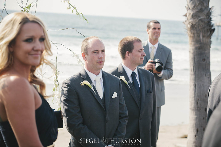 grooms firs look at his bride walking down teh aisle