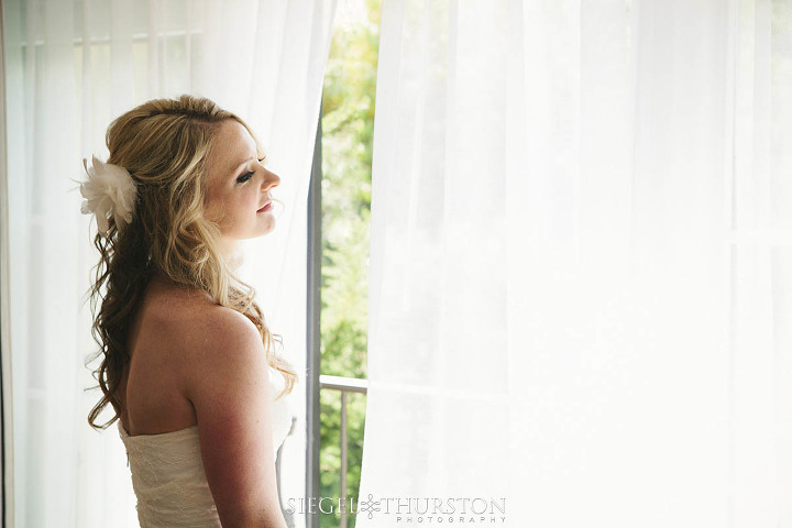 bride standing in the window at Estancia Hotel and Spa