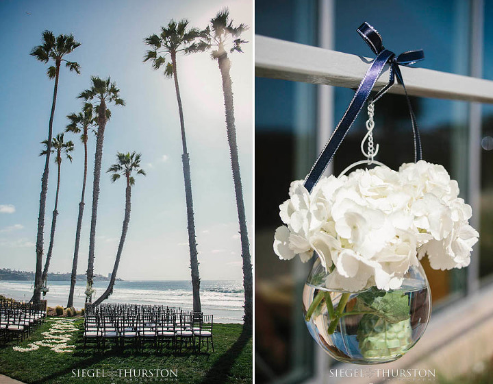 white flowers in little hanging globes lining the aisle