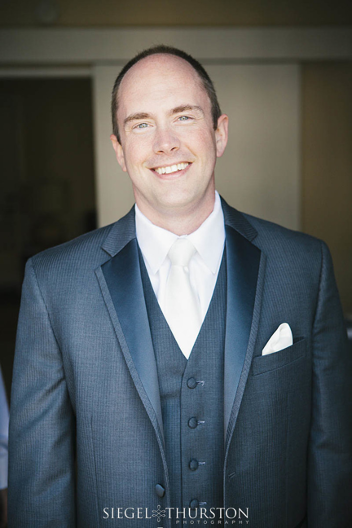 handsome groom in a gray suite with gray vest