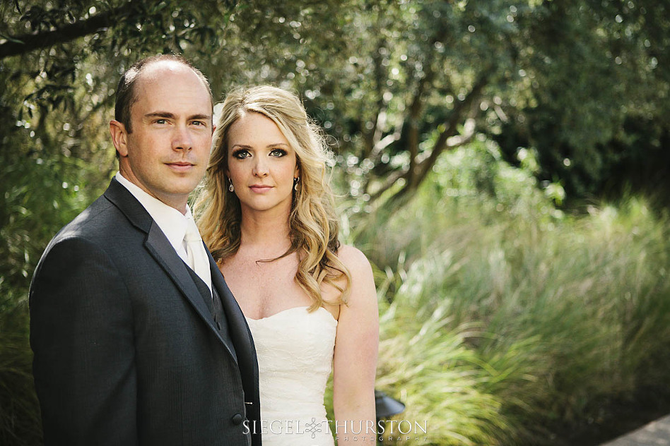 bride and groom looking like models at estancia la jolla