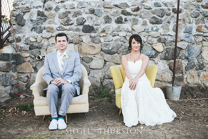 Up style photos of the bride and groom in funky vintage chairs