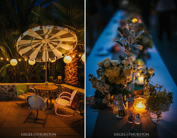 center piece consisting of mason jars, books, ceramic birds, yellow and white flowers