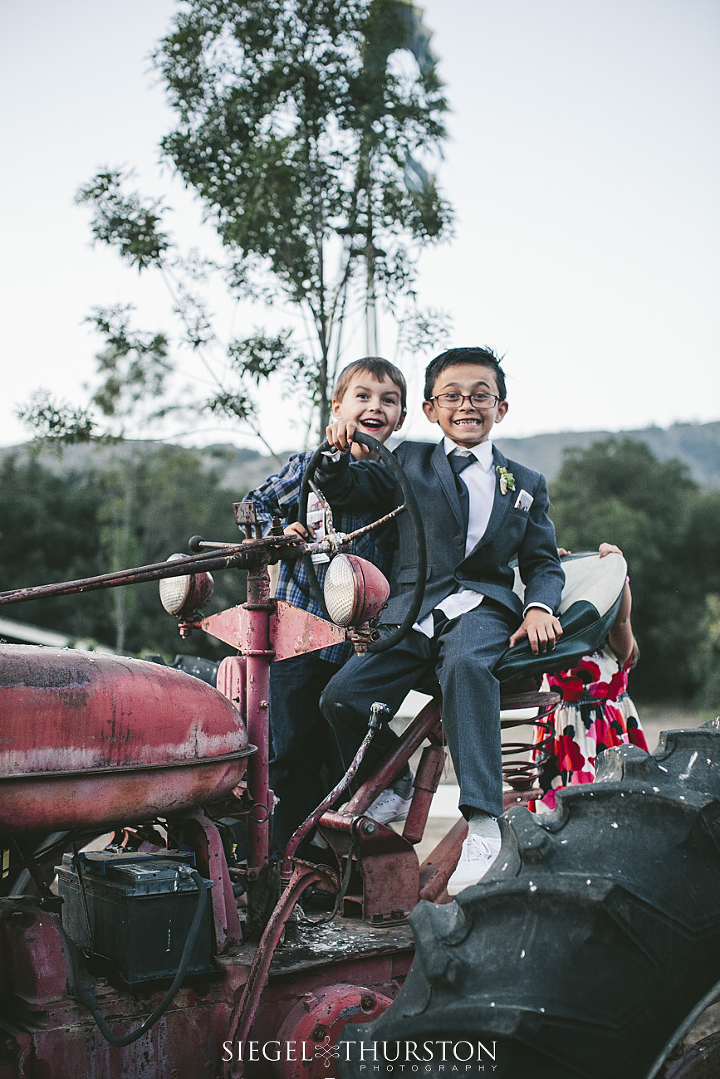 kids playing on a tractor at a barn wedding in southern california