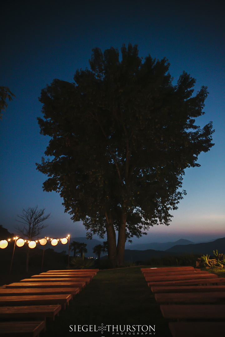 evening wedding ceremony site under a huge tree in Pala California