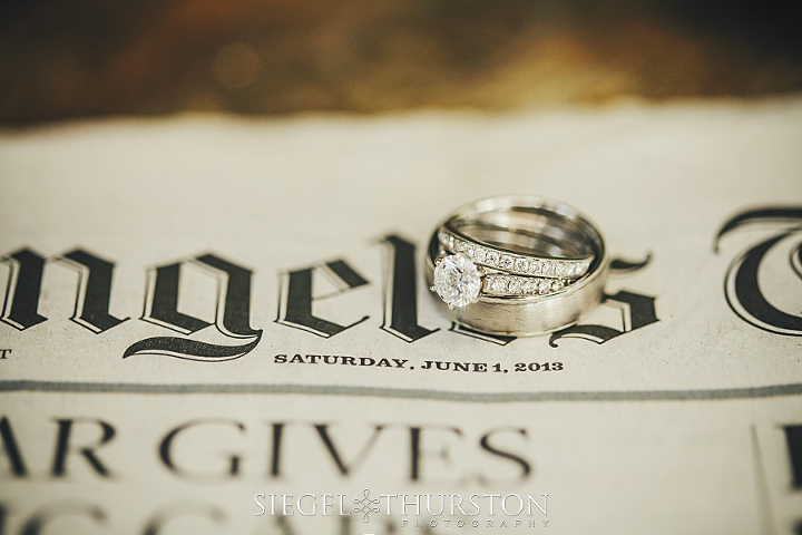 Wedding rings on a news paper from the day Tresa and Nate got married