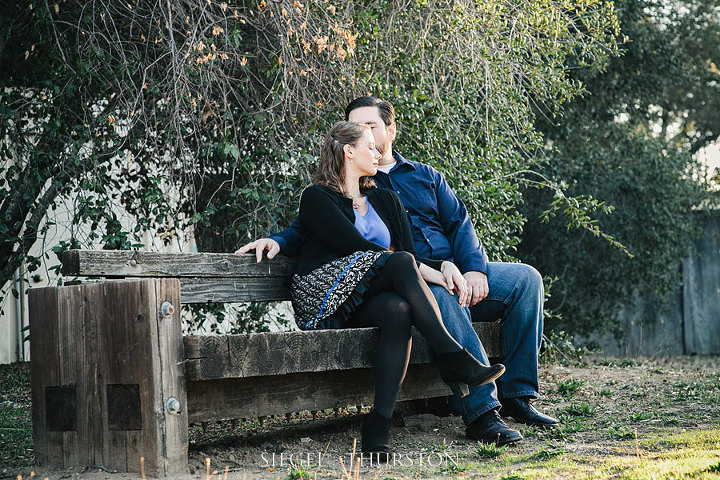 cute Julian california engagement photos on a rustic wooden bench