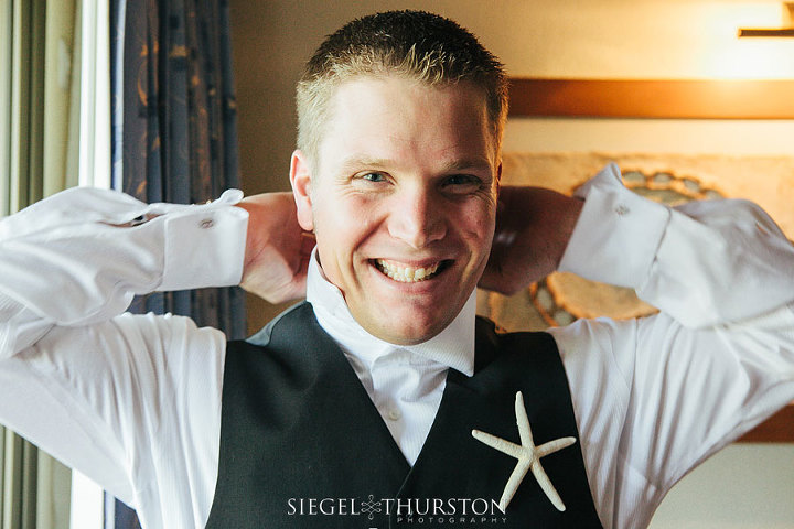 excited groom getting ready for his beach destination wedding