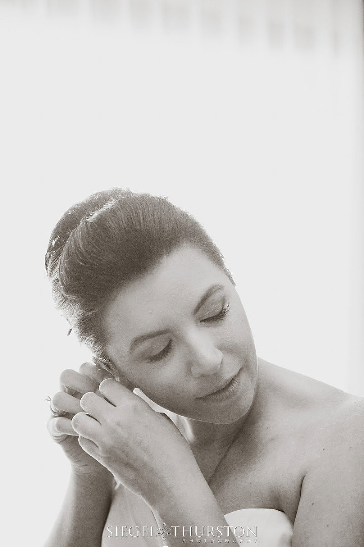 beautiful bride getting ready in front of the window for her beach destination wedding