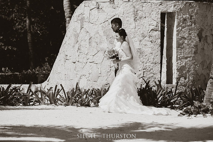 father of the bride walking his little girl to her beach wedding ceremony