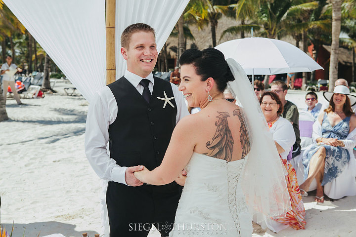 beach wedding emotional photo of the groom laughing at the ceremony