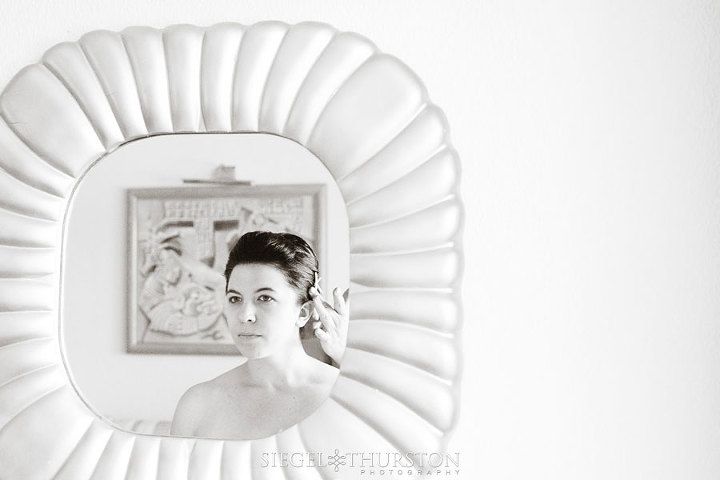 bride looking in the mirror before her wedding