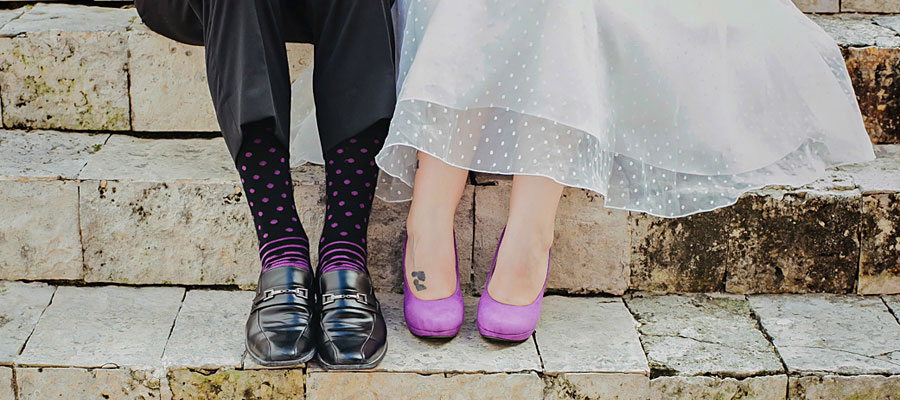 trash the dress playa del carmen destination wedding bride and groom wearing matching purple shoes and socks
