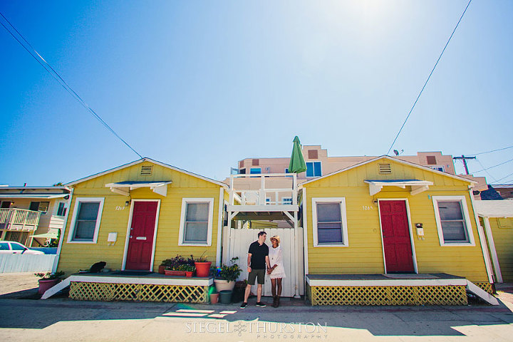 mission beach engagement photos in front of vintage san diego bungalows