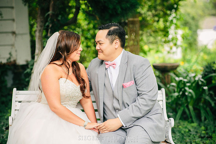 romantic wedding photos on a white bench in San Diego