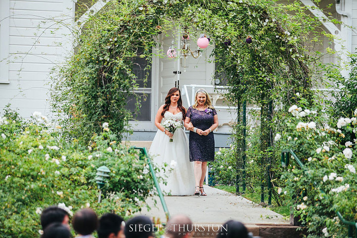 bride walking down the aisle with her mom