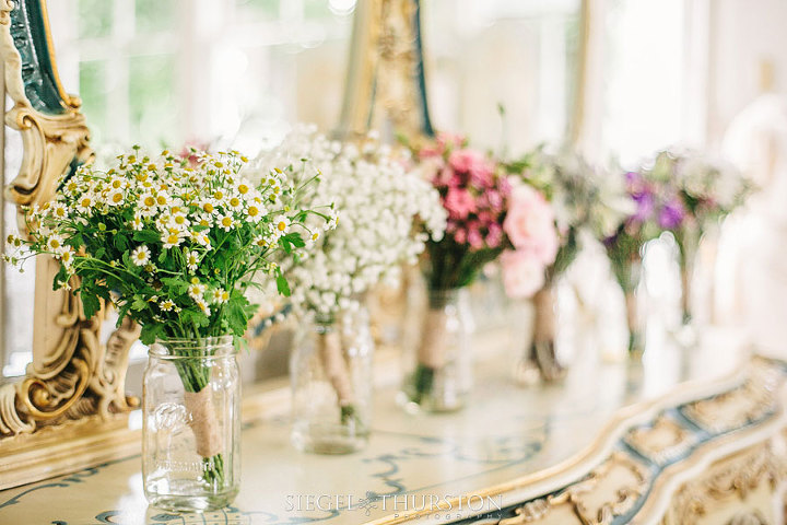 bride and bridesmaids flowers in mason jars on a vintage dresser in the bridal suite at Green Gables Estates in San Diego