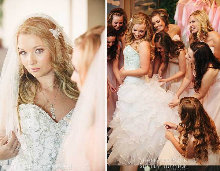 fun picture of the bridesmaids laughing and helping the bride into her wedding dress