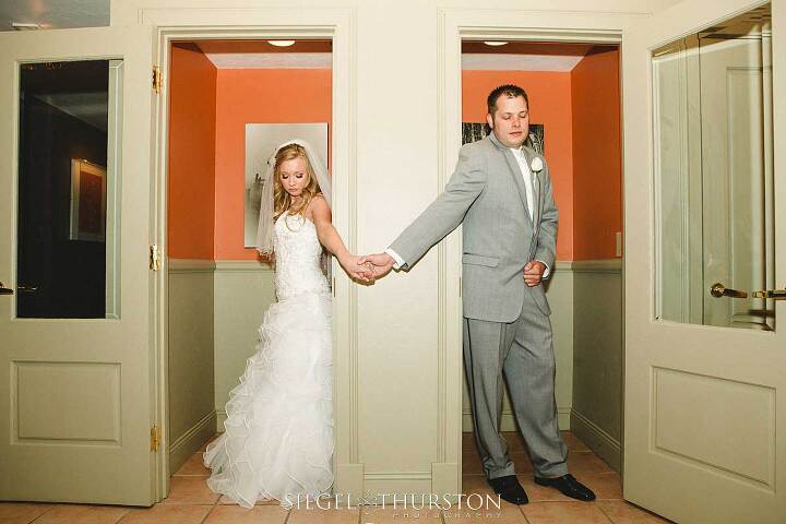 bride and groom having a pre wedding prayer from two phone booths so that they wont see one another before the ceremony