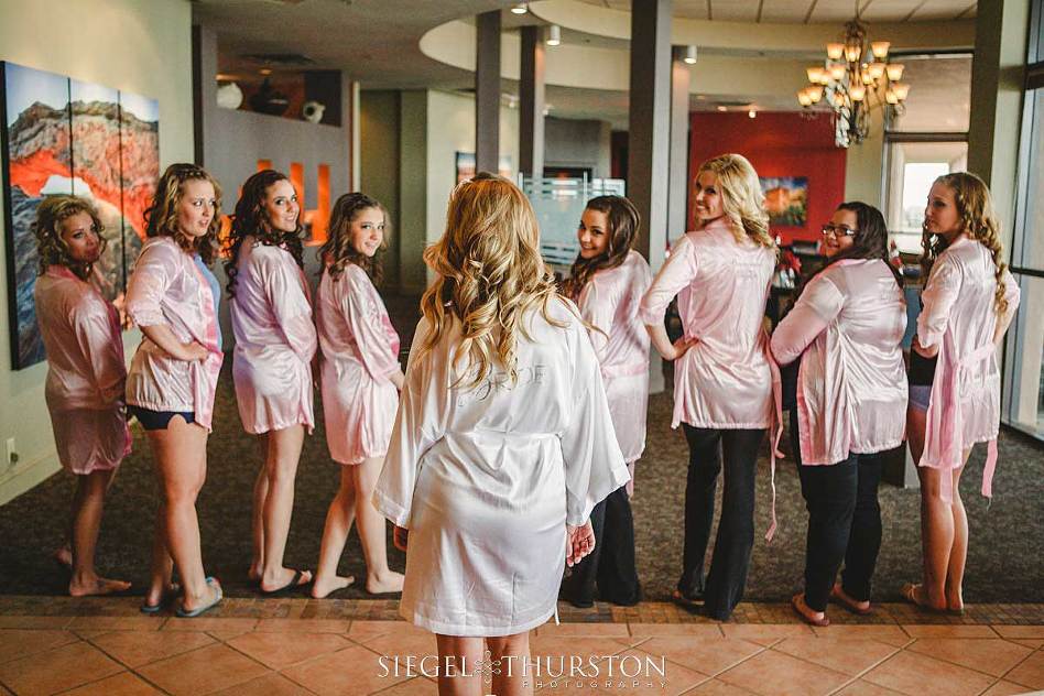 bride and her bridesmaids all in matching getting ready silk robes 