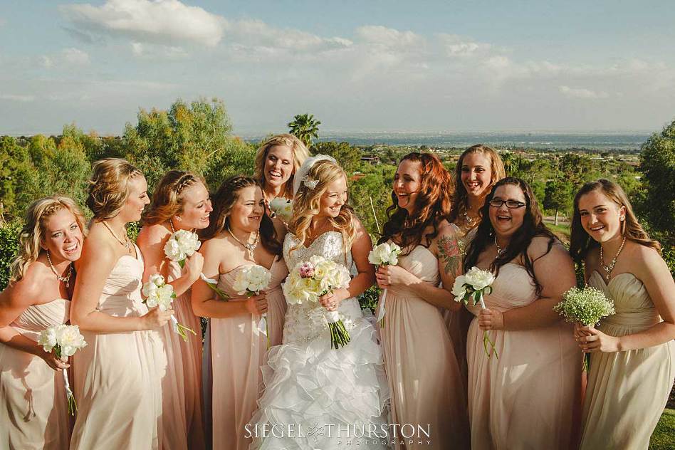 bride and her bridesmaids all laughing 