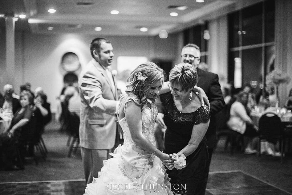 candid moment between the bride and her mother in law