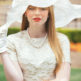 classic outfit for opening day at the races with a big white hat and everything.