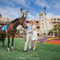 syled engagement shoot with a race horse at the del mar track