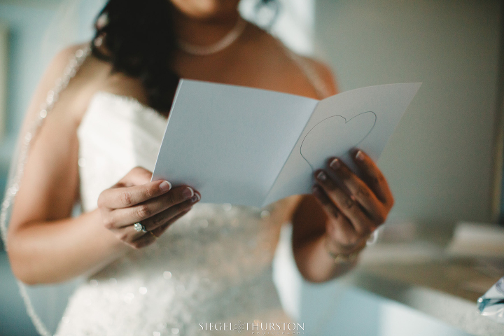 bride reading a letter from her future husband before their wedding ceremony