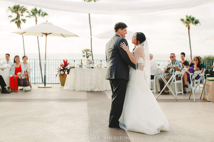 bride and groom first dance on the rooftop of La Jolla Cove Suites 
