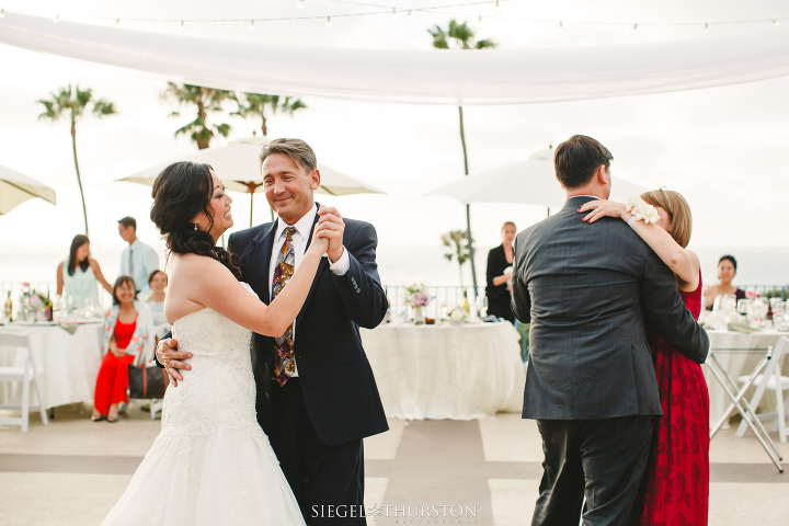family dancing on rooftop balcony for a La Jolla Cove Suites Wedding