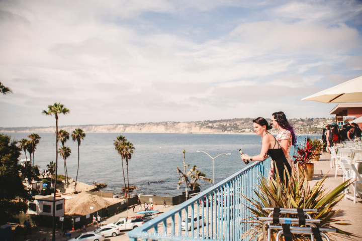 wedding guests looking out at the amazing view from La Jolla Cove Suites rooftop 