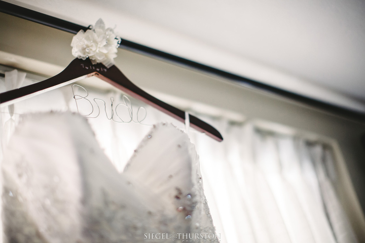 wedding dress on custom metal and wood hanger