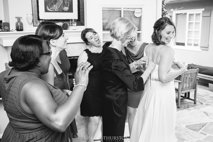 gorgeous bride getting into her wedding dress before her scripps la jolla wedding in california