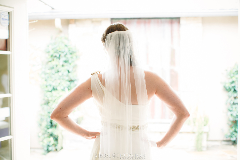 romantic moment of the bride standing in the door way before her wedding in la jolla California