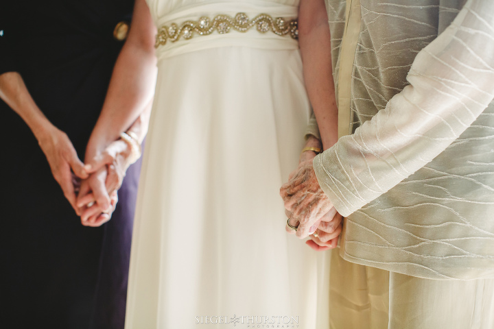 mother daughter and grandmother holding hands before the wedding