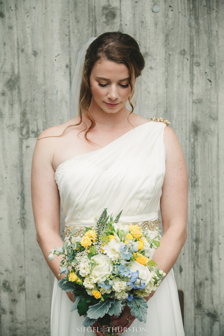 bride in greek style one shoulder wedding dress for her outdoor la jolla wedding