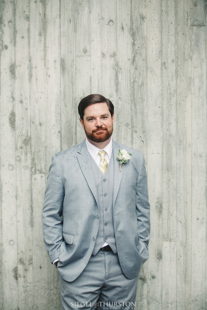 groom wearing a handsome gray suite and vest for his la jolla wedding