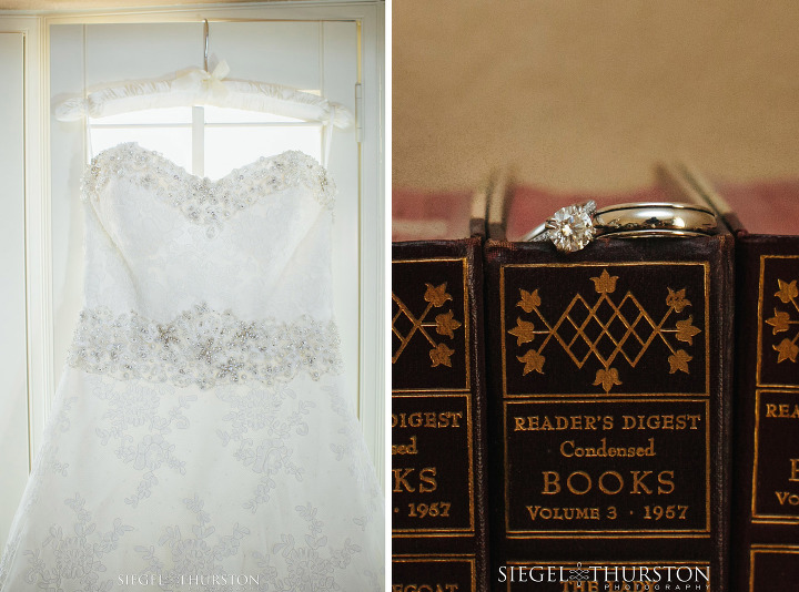 Lace strapless wedding dress hanging in window. 