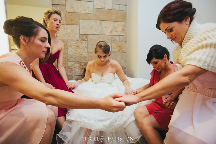 watermark church wedding bride and her bridesmaids praying in the bridal suite