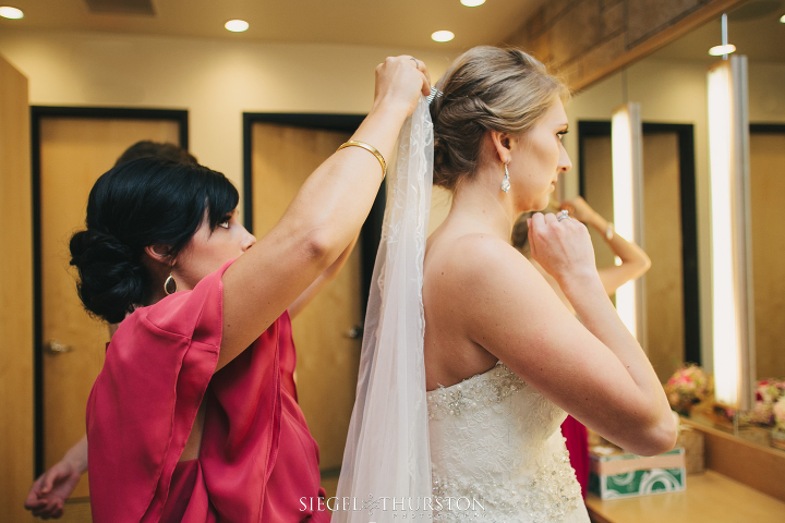 bride putting her veil on at the watermark church Dallas Texas