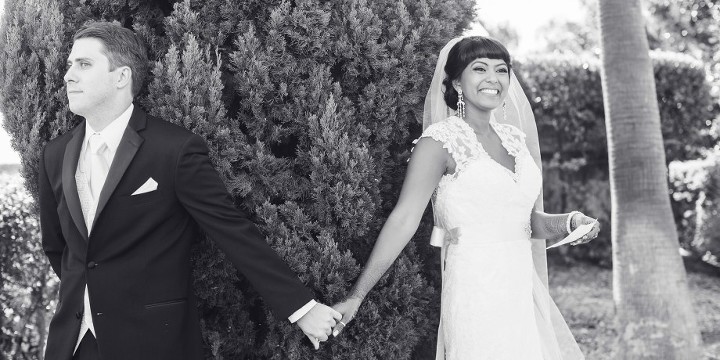 Bride and groom having a moment and holding hands without seeing one another before their wedding ceremony The Dana on Mission Bay