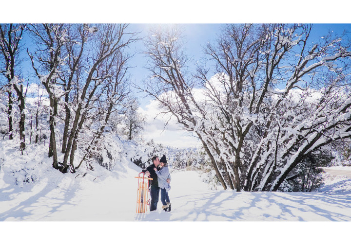 romantic winter engagement shoot with a vintage sled