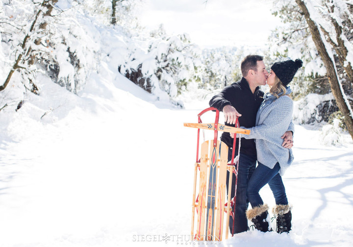 romantic winter engagement shoot with a vintage sled